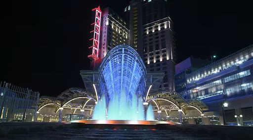 Illuminated glass atrium and fountains of Fallsview Casino Resort glowing at night